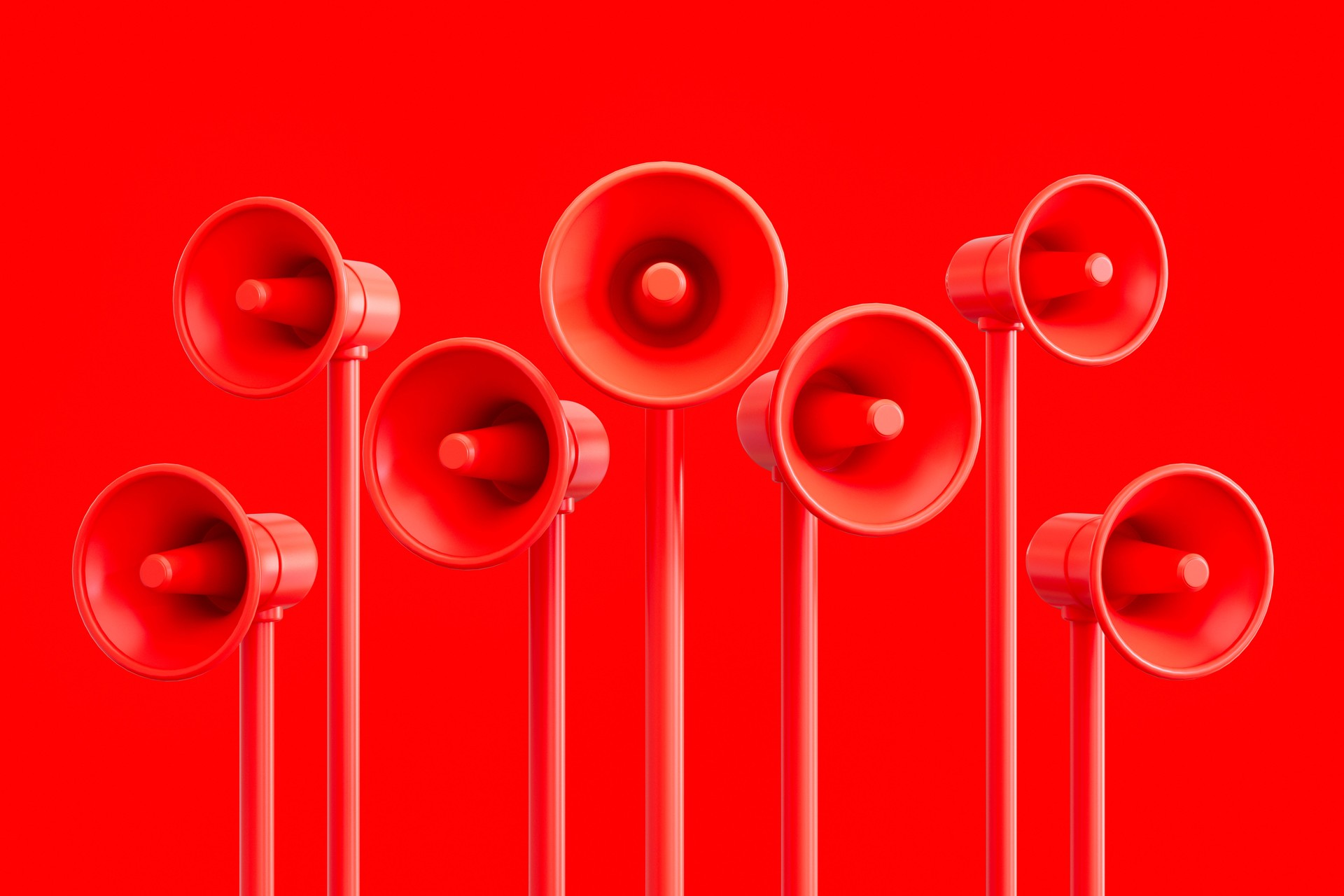 Megaphones on red background